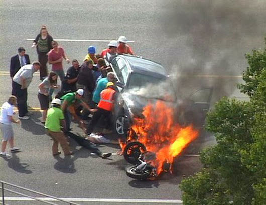 When a trapped motorcyclist was helped by bystanders who literally lifted the car off him.