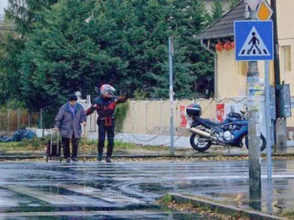 When this motorcyclist got off his bike to halt traffic, so that an elderly woman would make it to cross the street.