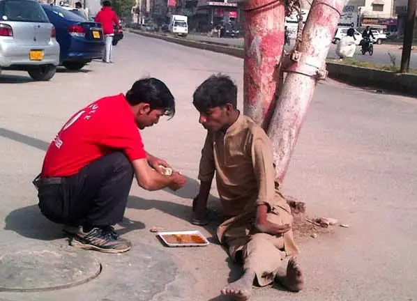 When this shop owner left his business for a while to feed this disabled homeless man.