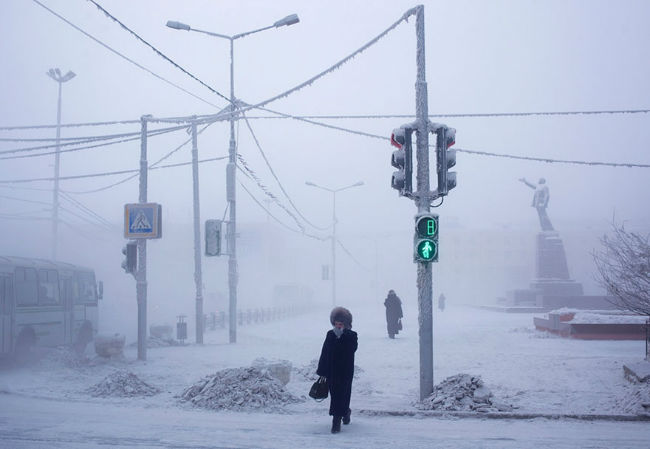 A resident of Oymyakon crosses a snowy streetlogspot.com