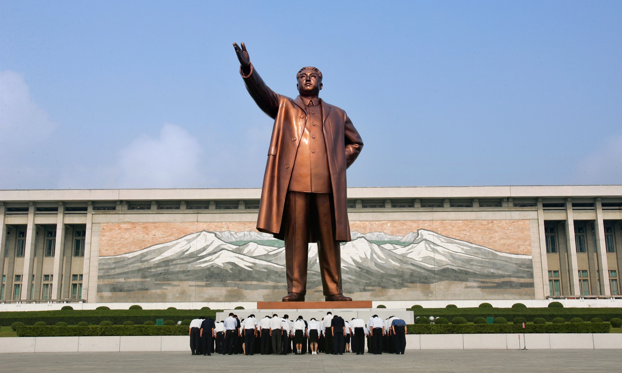 North Koreans bow before the statue of the late North Korean leader Kim Il Sung 
