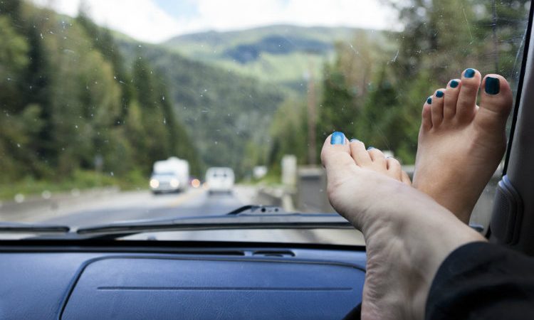 feet up on a car’s dashboard