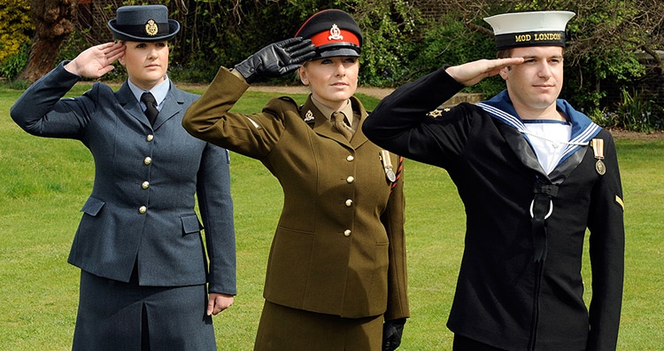 Personnel from the Royal Air Force, the British Army and the Royal Navy saluting