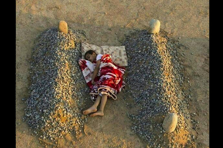 Syrian Boy Sleeping Between Parents' Graves