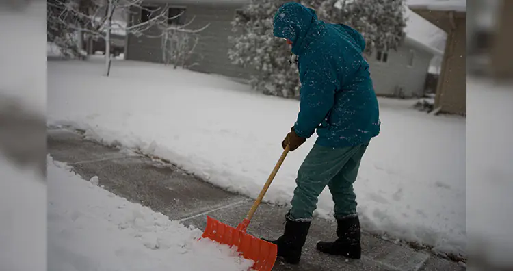 Person shovels snow off his sidewalk