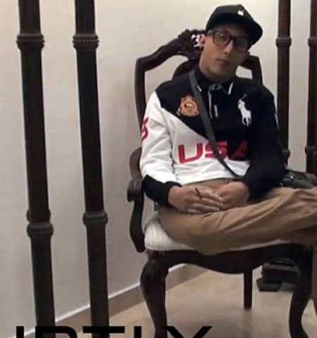 Picture Dead man sitting in chair attends his own funeral dressed casually holding his cigarette