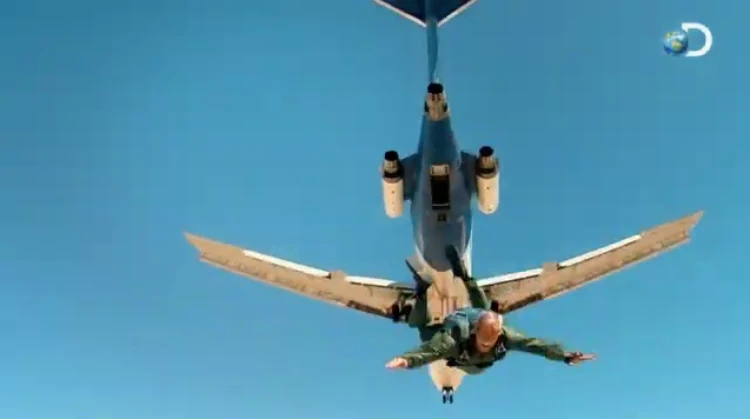 Pilot parachuting out of the plane during the crash test