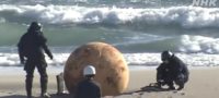 Picture Mysterious Metal Ball on Japan’s Pacific Shoreline Baffles Locals