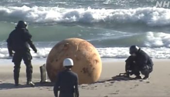 Picture Mysterious Metal Ball on Japan’s Pacific Shoreline Baffles Locals