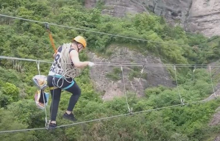 A store operator reaching the store via zipline while carrying refreshment