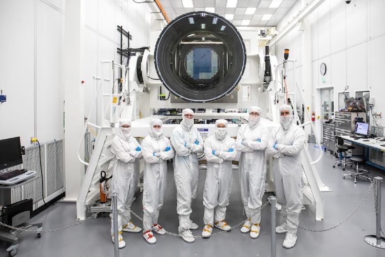 Scientists pose with the LSST camera