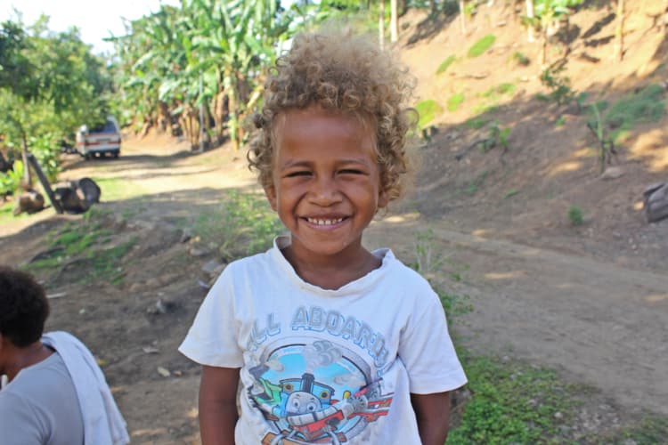 A young blonde boy from the Solomon Islands