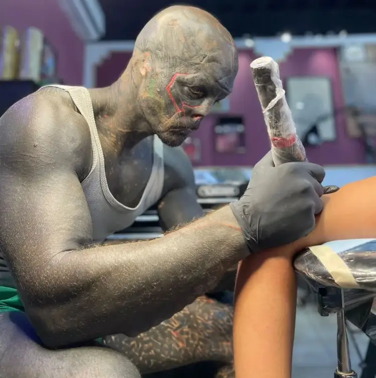 Anthony working as a tattoo artist.